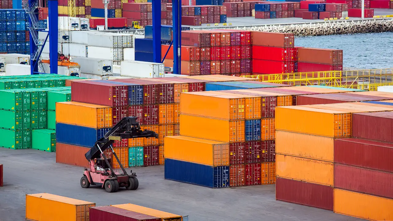 Reach stacker moving shipping containers at a freight terminal